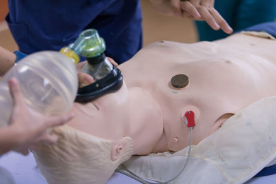 Cropped image of person learning cpr in hospital