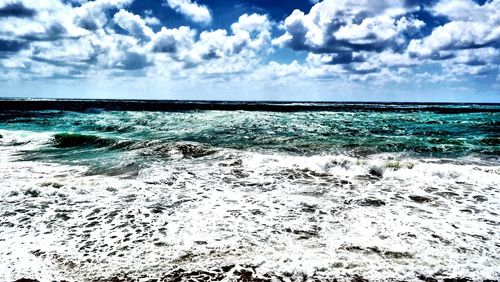 Scenic view of sea against cloudy sky