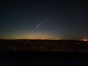 Scenic view of landscape against sky at night