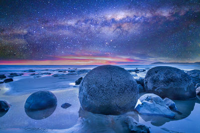 Scenic view of sea against sky at night