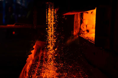 Illuminated fire on building at night