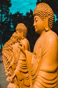 Statue of buddha against building