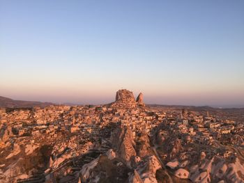 Rock formation against clear sky during sunset