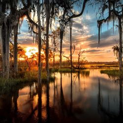 Scenic view of lake against sky during sunset