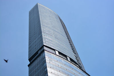 Low angle view of modern building against clear blue sky