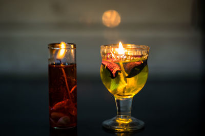 Close-up of lit tea light candles on table