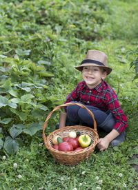 Portrait of woman picking food in wicker basket