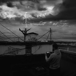 Silhouette of people against cloudy sky