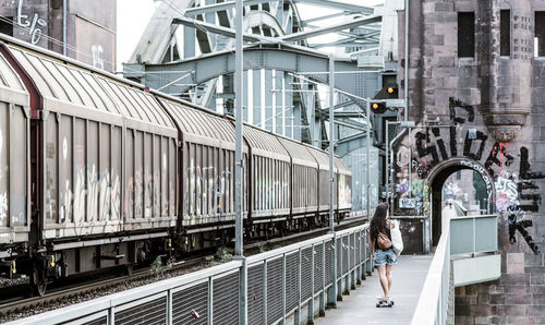 Rear view of girl on bridge with skate