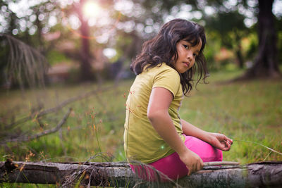 Side view of girl against trees