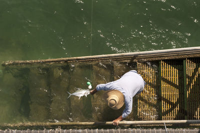 Directly above view of man fishing in sea