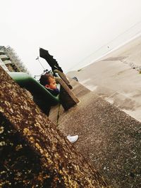 High angle view of girl on beach against clear sky