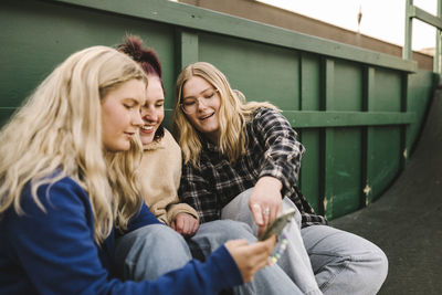 Teenage girls using smart phone