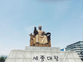 Low angle view of statue against sky