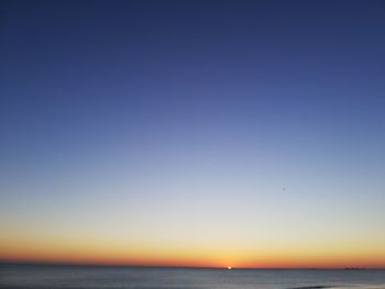 Scenic view of sea against clear sky during sunset