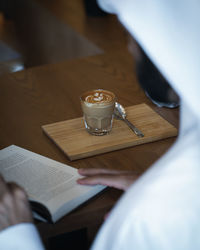 Man holding coffee cup on table