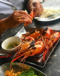 Midsection of man having food in plate