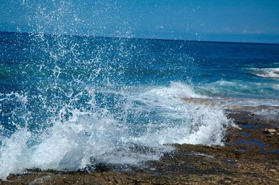 Scenic view of sea against blue sky