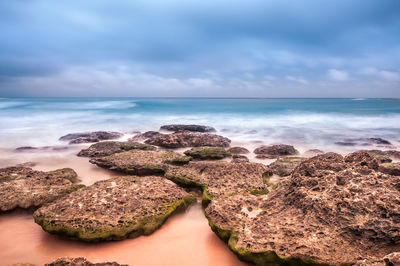 Scenic view of sea against cloudy sky