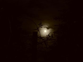Low angle view of illuminated street light against sky