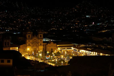 High angle view of illuminated buildings in city at night