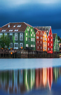 Reflection of building in lake against sky