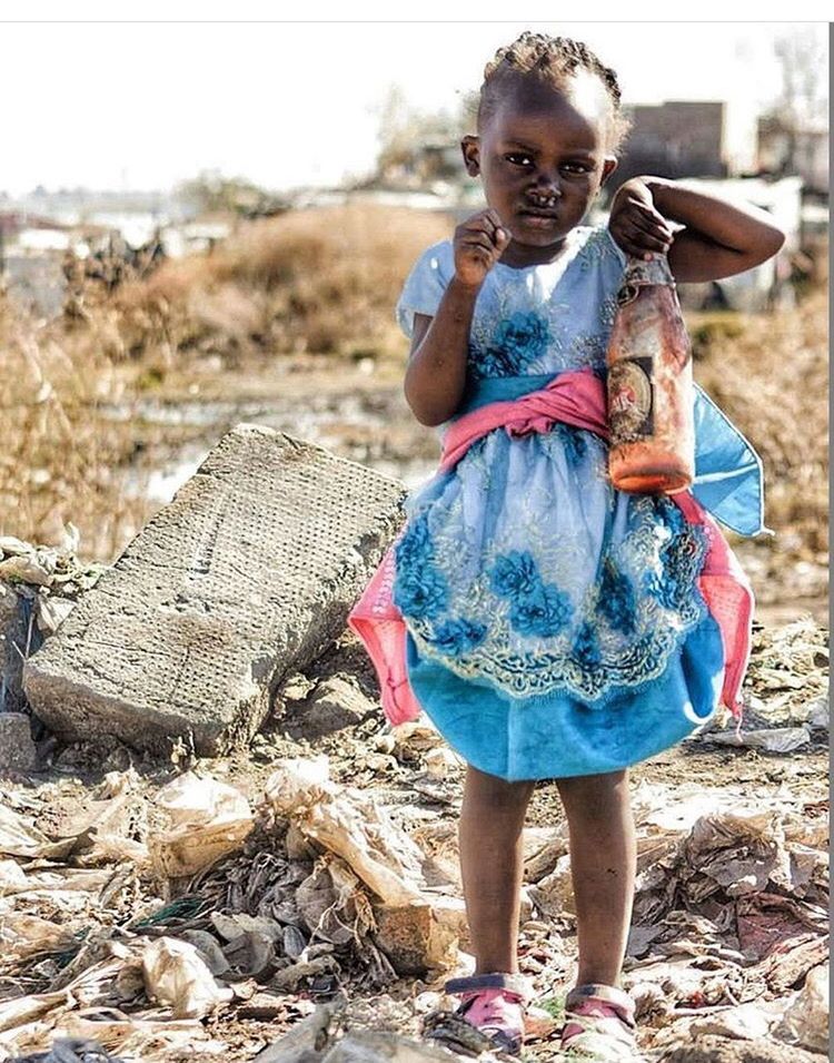 child, one person, childhood, girls, full length, front view, casual clothing, day, real people, females, looking at camera, leisure activity, land, women, portrait, dirt, lifestyles, focus on foreground, innocence, outdoors, dirty, messy