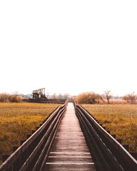 Boardwalk against clear sky