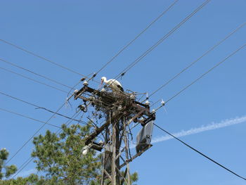 Low angle view of electricity pylon against sky