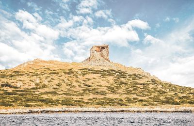 Low angle view of rock formations against sky