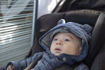 Portrait of cute baby girl in car
