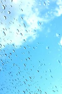 Low angle view of airplane flying against blue sky