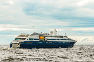 Ship sailing on sea against sky