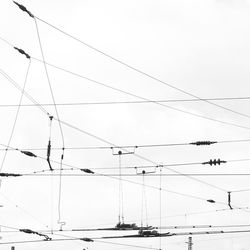 Low angle view of power lines against clear sky