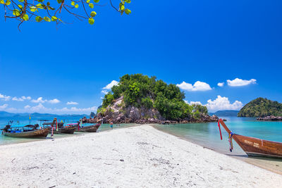 Scenic view of beach against blue sky