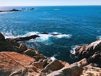 Scenic view of sea against blue sky