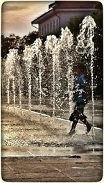 Full length of woman standing on railing