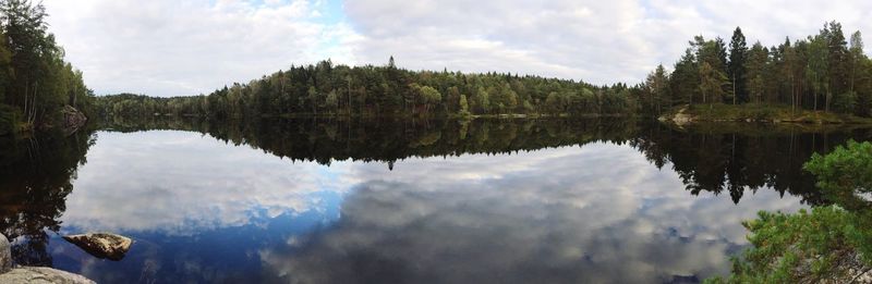 Panoramic view of lake and trees against sky