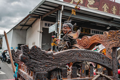 Low angle view of statues on building against sky