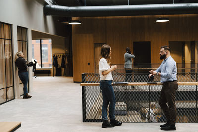 Coworkers talking at corridor