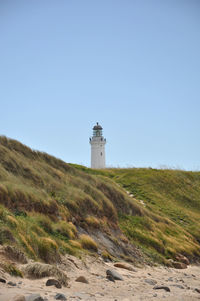 Lighthouse on land against clear sky