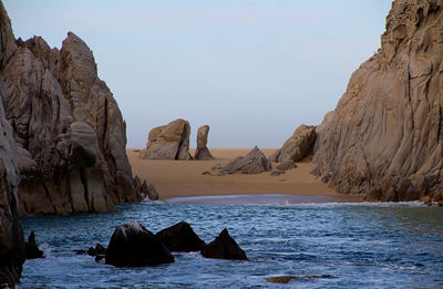 Scenic view of rocks in sea against sky