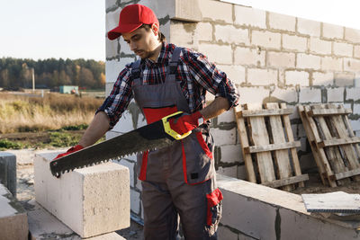 Rear view of man working at construction site