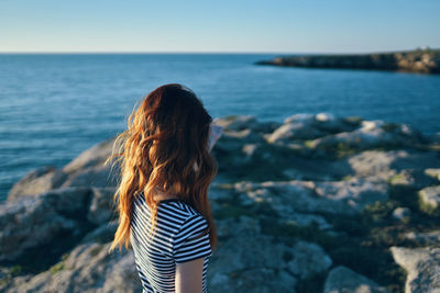 Rear view of woman looking at sea