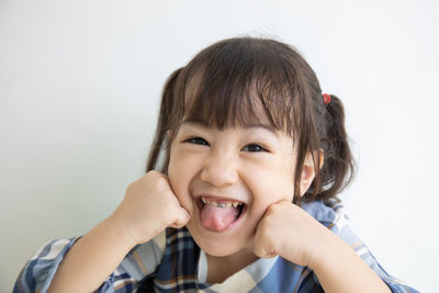 Portrait of smiling girls against white background