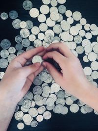 High angle view of hand holding coins