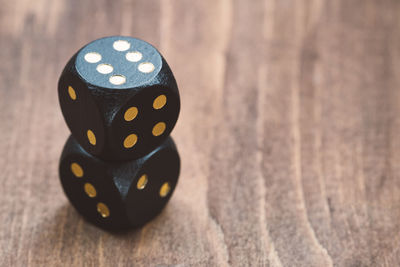 Close-up of stacked black dices on table