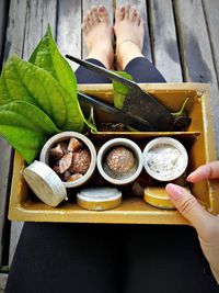 High angle view of woman preparing paan on boardwalk