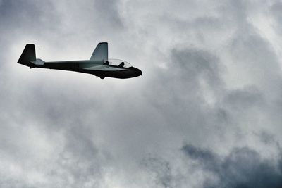 Low angle view of fighter plane flying against sky