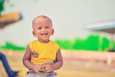 Portrait of smiling boy standing outdoors